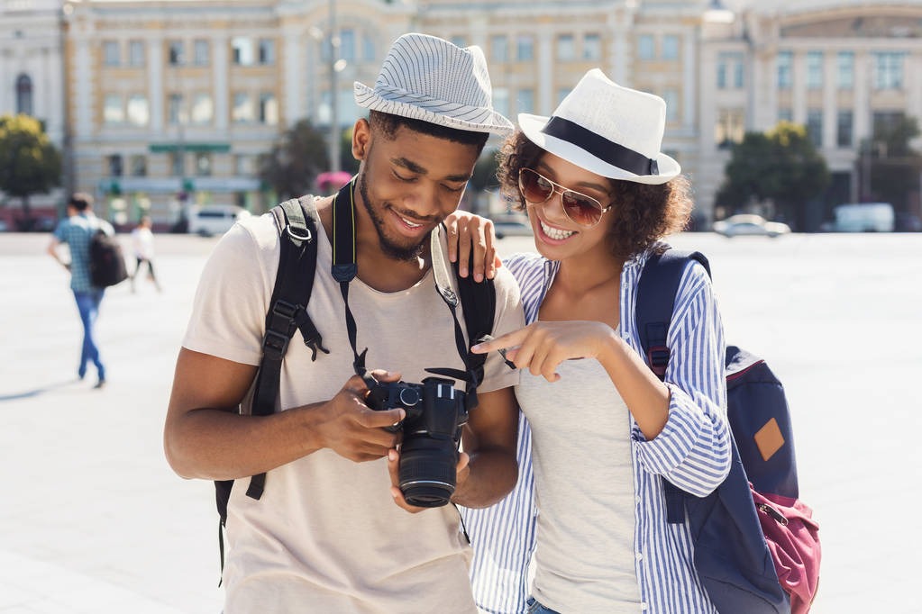 stock photo loving couple looking on their photos on camera